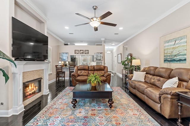 living room with ceiling fan, ornamental molding, and dark hardwood / wood-style flooring