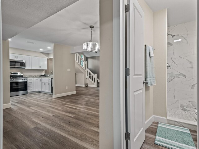 2191 Shangri La Ln E Unit 12B, Tallahassee, FL 32303 - kitchen featuring stainless steel appliances, dark wood-style floors, white cabinets, baseboards, and recessed lighting