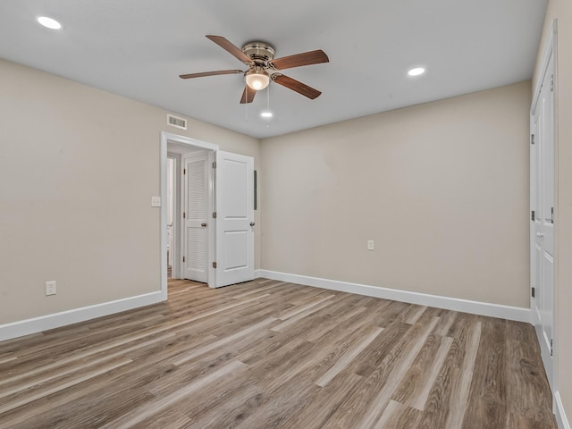 2191 Shangri La Ln E Unit 12B, Tallahassee, FL 32303 - unfurnished bedroom featuring light wood-style flooring, baseboards, and recessed lighting