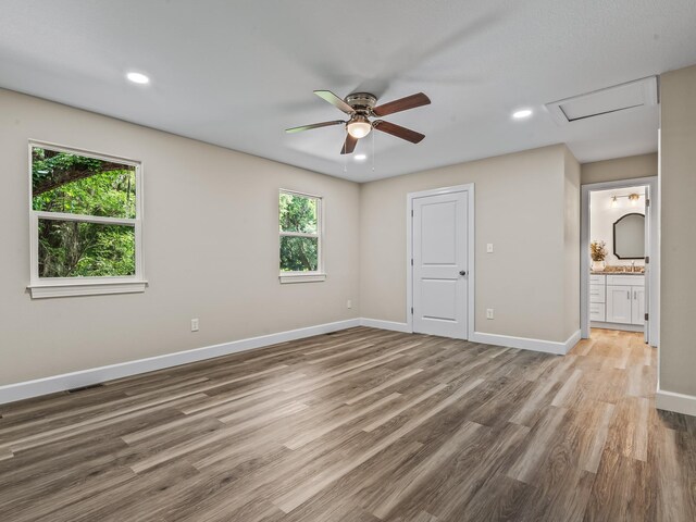 2191 Shangri La Ln E Unit 12B, Tallahassee, FL 32303 - unfurnished bedroom with attic access, baseboards, wood finished floors, connected bathroom, and recessed lighting