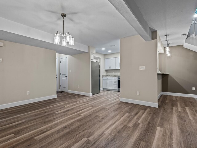 2191 Shangri La Ln E Unit 12B, Tallahassee, FL 32303 - unfurnished living room featuring dark wood-style floors, baseboards, and recessed lighting