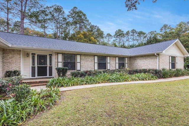 single story home featuring a front lawn