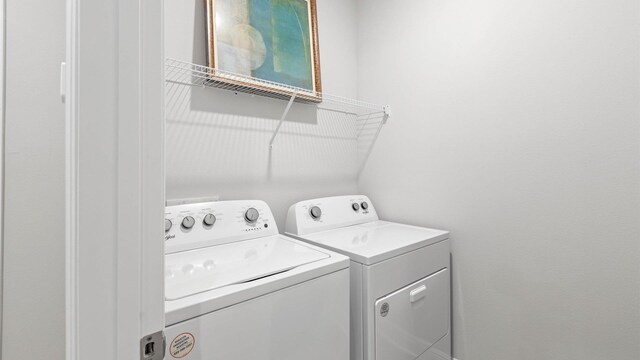 washroom featuring washing machine and dryer