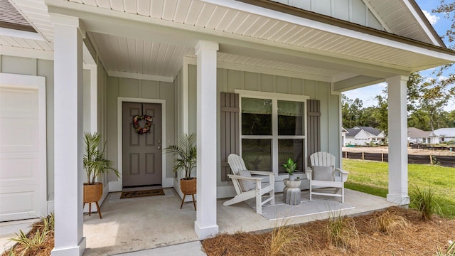 entrance to property with a garage and covered porch