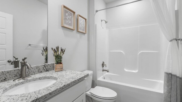 full bathroom with shower / tub combo with curtain, vanity, and toilet