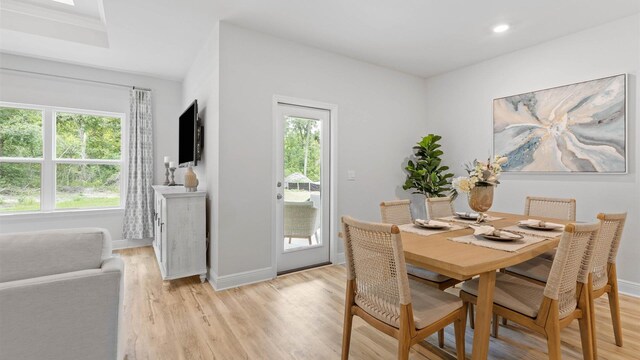 dining space with light hardwood / wood-style flooring and plenty of natural light