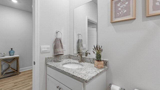 bathroom featuring hardwood / wood-style flooring and vanity