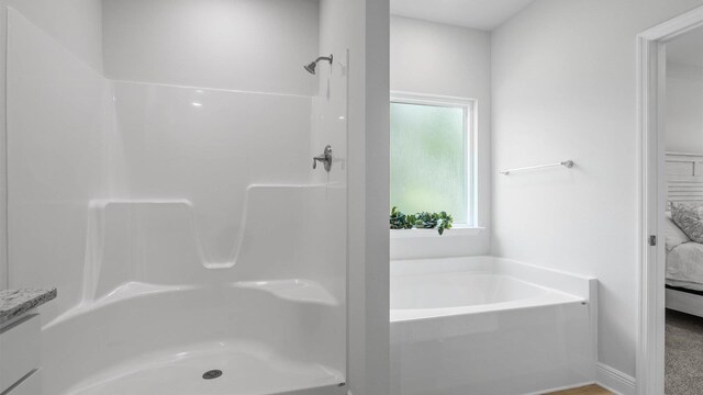 bathroom with a tub to relax in