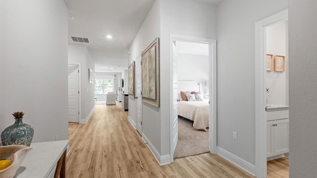 hallway with light hardwood / wood-style flooring