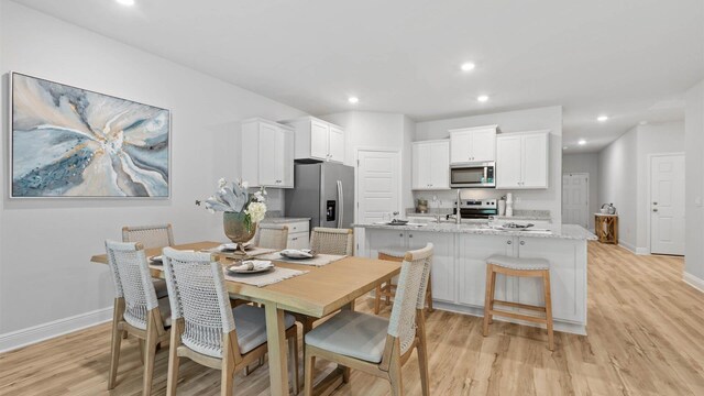 dining space featuring light hardwood / wood-style flooring