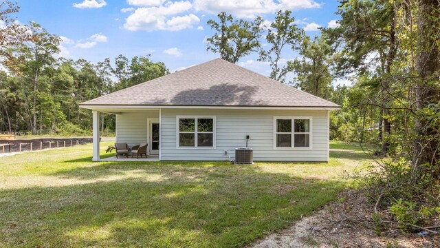 back of house featuring cooling unit, a yard, and a patio area