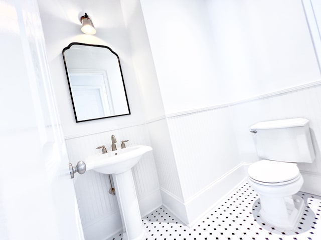 bathroom with tile patterned flooring and toilet