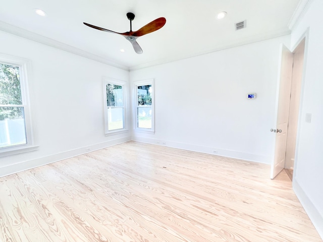 empty room featuring crown molding, ceiling fan, and light wood-type flooring