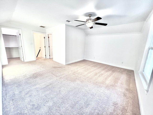 carpeted empty room with ceiling fan and lofted ceiling