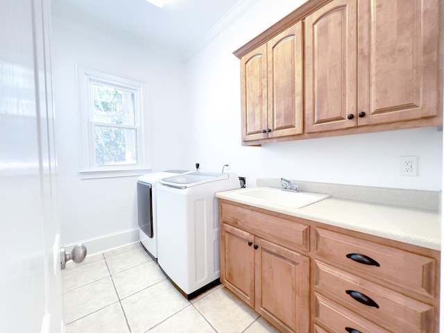 laundry room featuring sink, cabinets, light tile patterned floors, ornamental molding, and independent washer and dryer