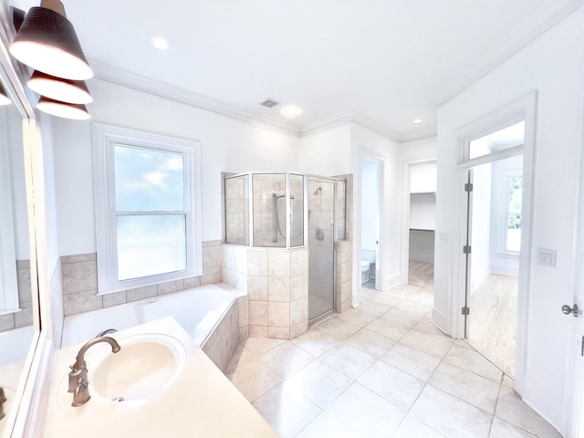 full bathroom featuring plus walk in shower, sink, tile patterned flooring, ornamental molding, and toilet