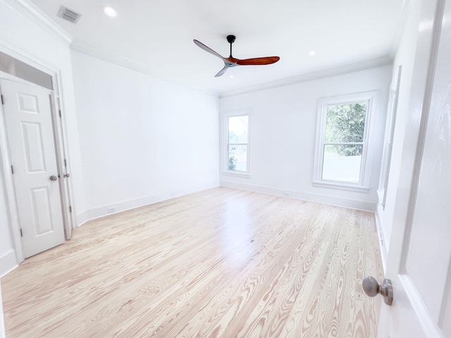 empty room featuring ceiling fan, ornamental molding, and light hardwood / wood-style floors