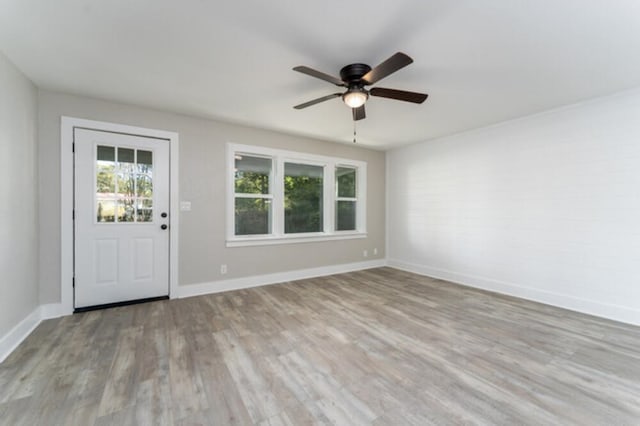 181 E Center St, Perry, FL 32348 - empty room with a ceiling fan and wood finished floors