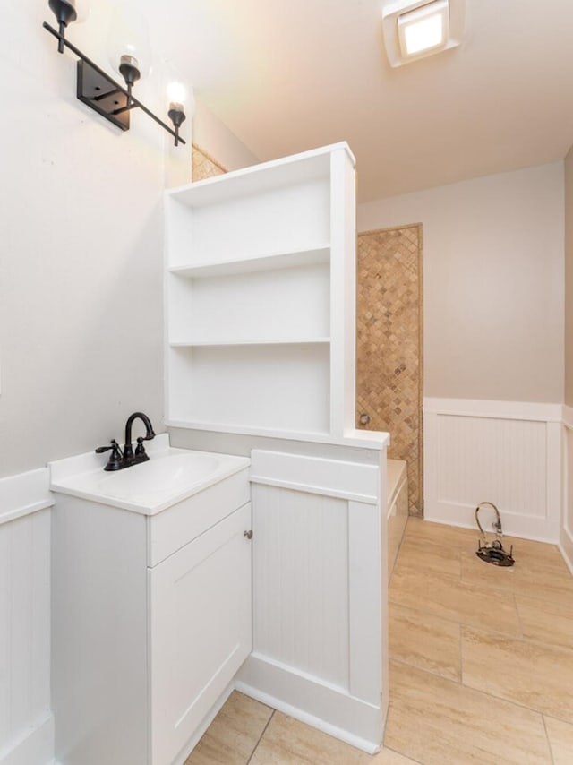 181 E Center St, Perry, FL 32348 - full bath with a wainscoted wall, a bathtub, a decorative wall, and vanity