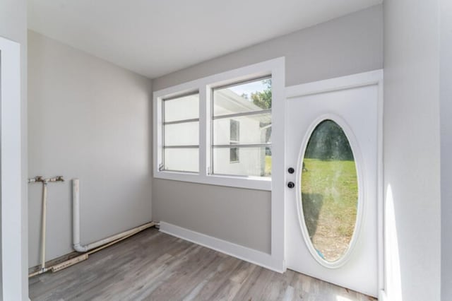 181 E Center St, Perry, FL 32348 - doorway to outside with wood finished floors and baseboards