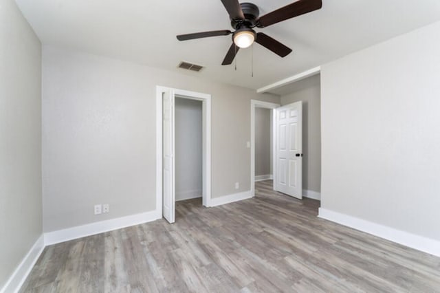 181 E Center St, Perry, FL 32348 - unfurnished bedroom with wood finished floors, a ceiling fan, and a closet