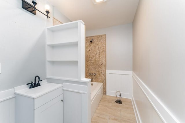 181 E Center St, Perry, FL 32348 - full bath featuring a wainscoted wall, vanity, a decorative wall, and shower / bath combination