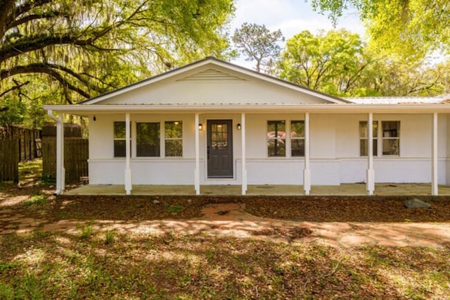 181 E Center St, Perry, FL 32348 - single story home with covered porch and a metal roof