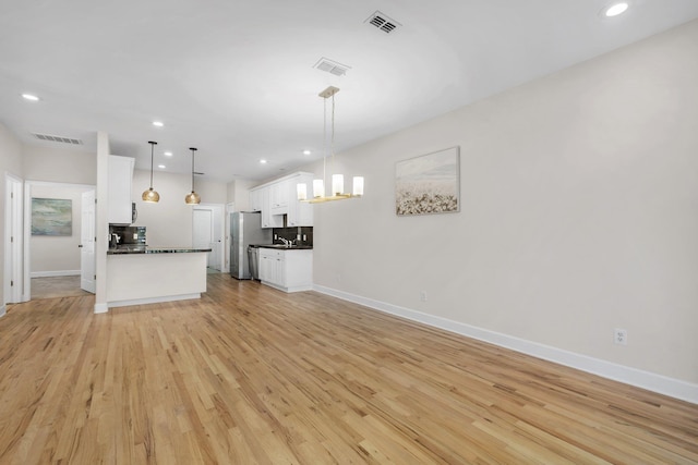 unfurnished living room with light hardwood / wood-style floors