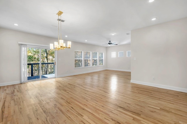 interior space featuring light hardwood / wood-style floors and ceiling fan with notable chandelier