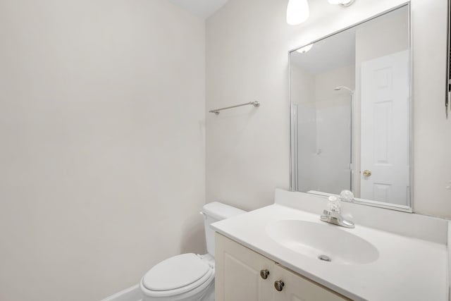 bathroom featuring a shower, vanity, and toilet