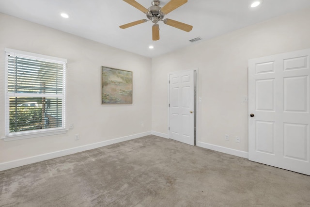 unfurnished bedroom featuring light colored carpet and ceiling fan