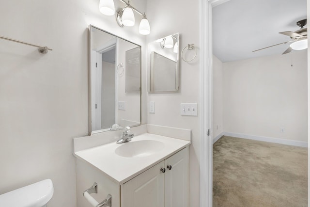 bathroom with ceiling fan, vanity, and toilet