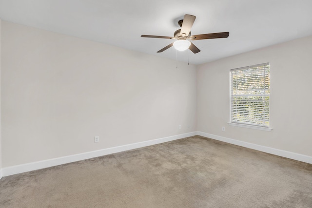 empty room with ceiling fan and carpet floors