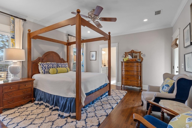 bedroom with ornamental molding, ensuite bathroom, ceiling fan, and dark hardwood / wood-style flooring