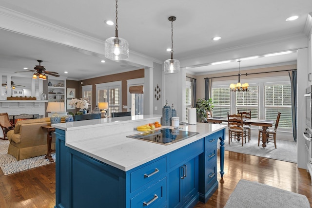 kitchen with dark hardwood / wood-style flooring, blue cabinetry, a kitchen island, black electric cooktop, and decorative light fixtures