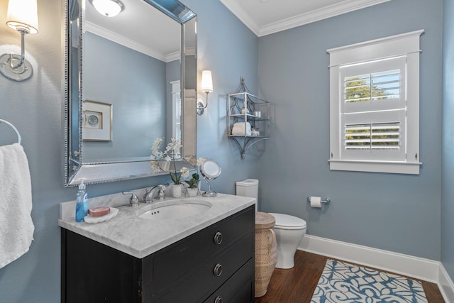 bathroom featuring crown molding, wood-type flooring, vanity, and toilet