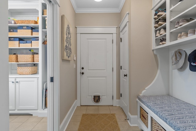 mudroom featuring crown molding and light tile patterned floors