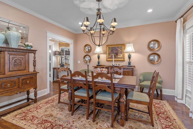 dining room featuring crown molding, an inviting chandelier, and hardwood / wood-style floors