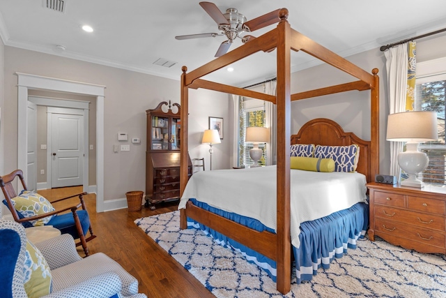 bedroom featuring crown molding, ceiling fan, and dark hardwood / wood-style flooring