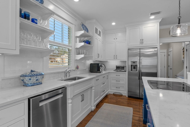 kitchen with white cabinetry, stainless steel appliances, light stone countertops, and sink