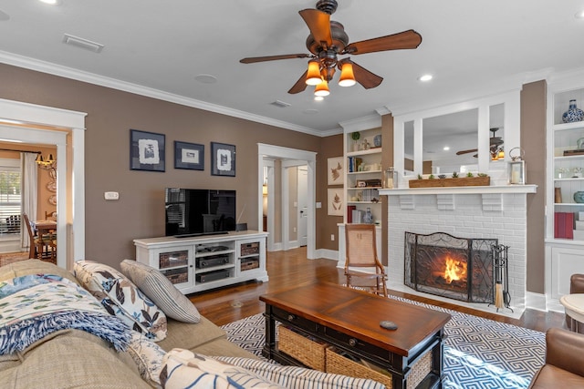 living room with ceiling fan, ornamental molding, hardwood / wood-style floors, and a brick fireplace