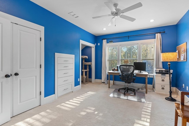 carpeted home office featuring ceiling fan