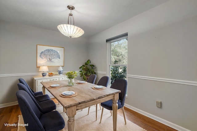 dining room with baseboards and wood finished floors