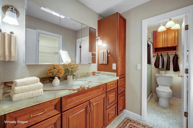 full bathroom with toilet, vanity, and baseboards