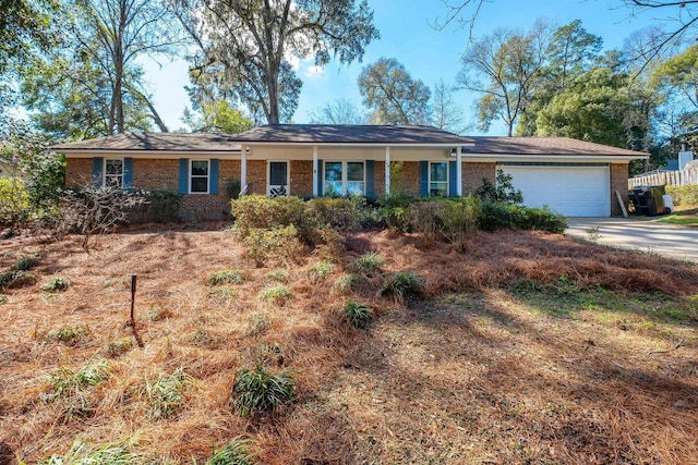 ranch-style house featuring a garage, concrete driveway, and brick siding