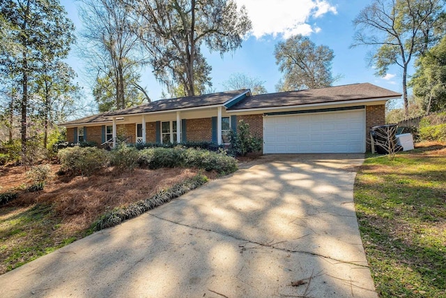 ranch-style home featuring concrete driveway, brick siding, and an attached garage