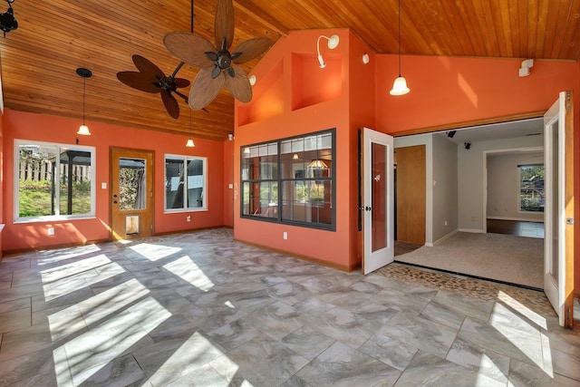 unfurnished sunroom featuring a ceiling fan, lofted ceiling, and wooden ceiling