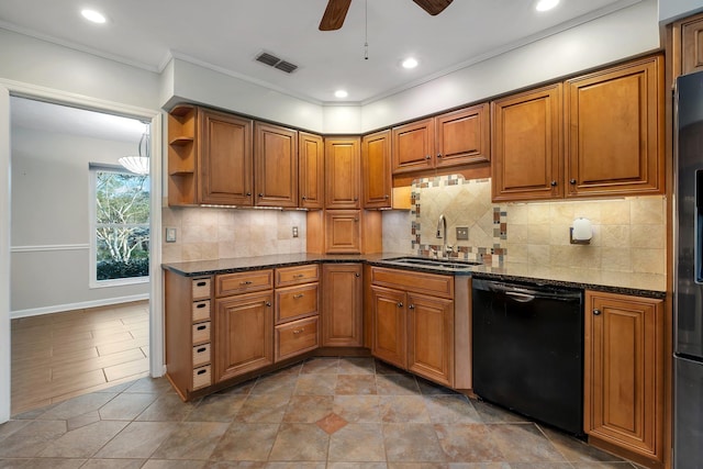 kitchen with dishwasher, brown cabinetry, a sink, and backsplash