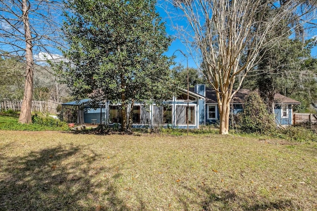 exterior space featuring a yard and fence