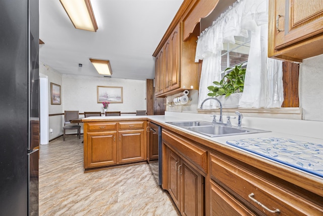 kitchen with kitchen peninsula, sink, refrigerator, and stainless steel dishwasher